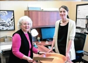 Ellen Edwards (daughter of John Tompson) and Kristin Hardie, archivist, examine the bowl